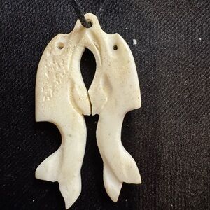 Carved Dolphin Fish Pendant Necklace on fabric chain.